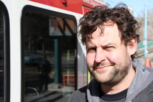 Author Chris Turner at a Calgary LRT system, a public transit system powered by the wind.
