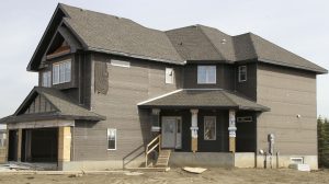 This 2,700 square foot half-done house in the community of Trumpeter in North Edmonton has 14 holes 32 metres deep that will provide all of the heat for the house.
