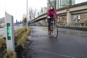 Erin O'Melinn is the executive director of HUB, Vancouver's largest cycling advocacy organization. Here she rides by a bike counter.