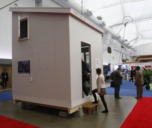 People step into the Nomad Microhome prototype on the trade show floor at GLOBE 2014. It’s 10x10 feet, is one and a half storeys tall and has all the comforts of a regular home. Photo Duncan Kinney, Green Energy Futures
