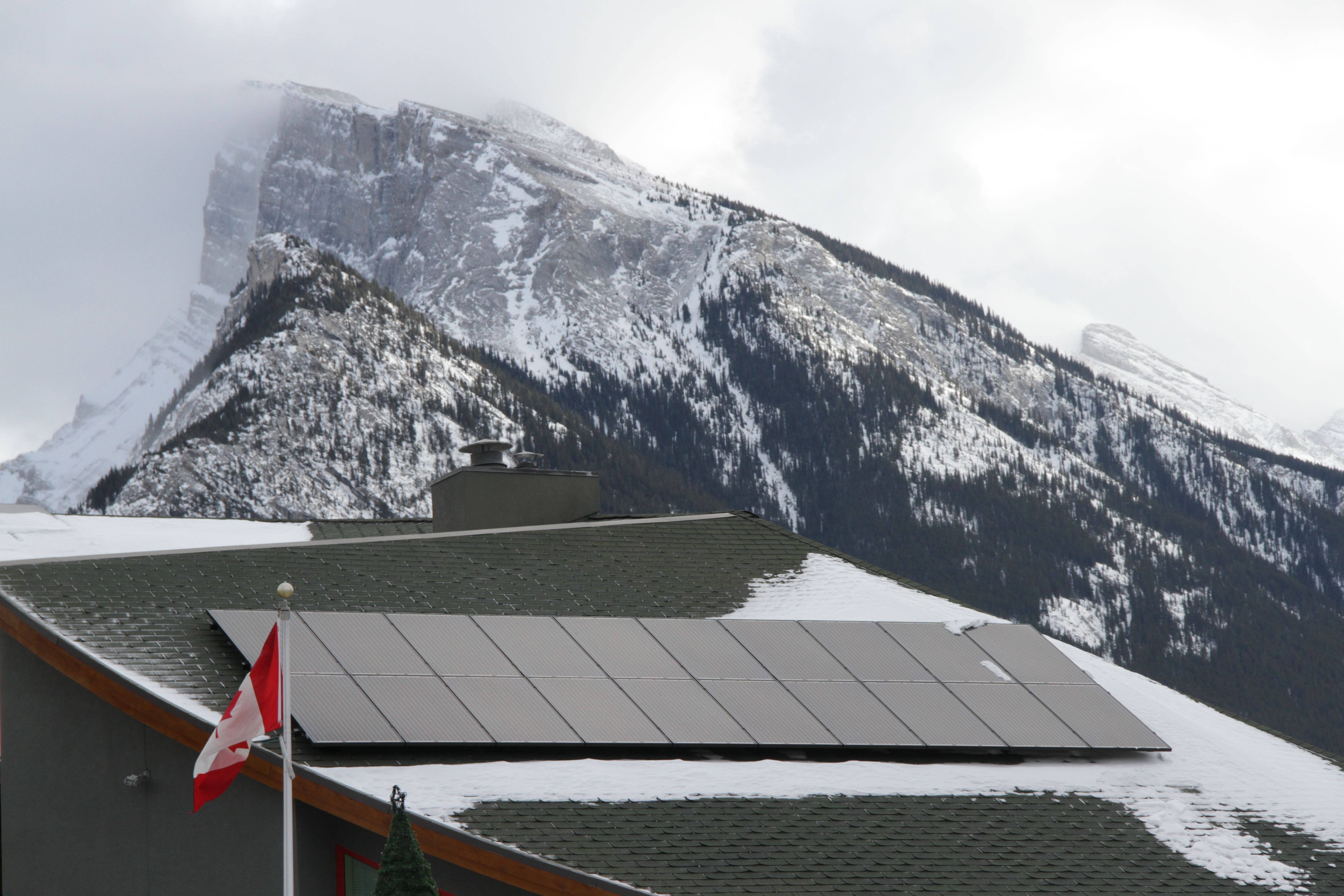 Solar on Banff Town Hall with famous Mount Rundle behind. Banff set up an environmental reserve fund using dollars from their municipal franchise fee. Photo David Dodge, Green Energy Futures