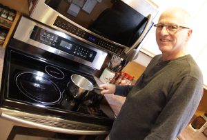 David Dodge with his induction range. It works incredibly fast and is more efficient than gas or standard electric burners.