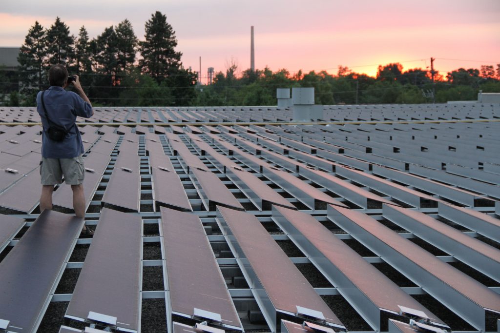Mike Brigham, the president of SolarShare, takes in a sunrise at SolarShare's WaterView project.